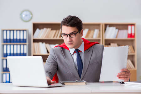 Superhero businessman working in the officeの写真素材