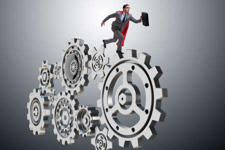 Businessman in teamwork concept with cogwheelsの写真素材