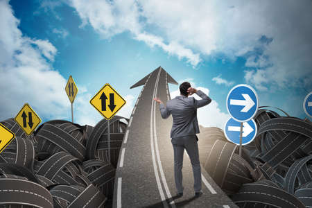 Businessman in uncertainty concept on road intersection crossroaの写真素材