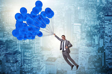 Businessman flying on balloon in challenge conceptの写真素材