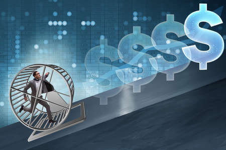 Business concept with businessman running on hamster wheelの写真素材