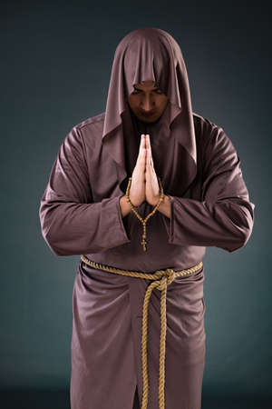 Monk in religious concept on gray backgroundの写真素材
