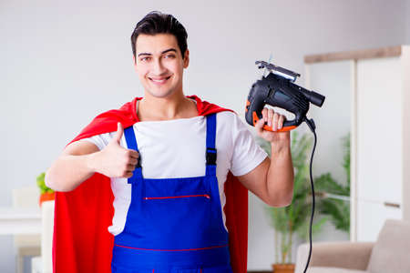 Superhero repairman with tools in repair conceptの写真素材