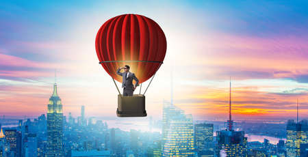 Businessman flying on balloon in challenge conceptの写真素材
