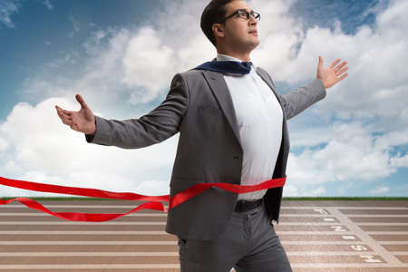 Businessman on the finishing line in competition conceptの写真素材