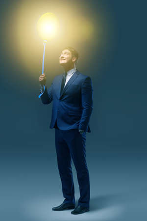 Businessman with bright balloon in business conceptの写真素材