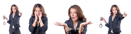 Female businesswoman with handcuffs on whiteの写真素材