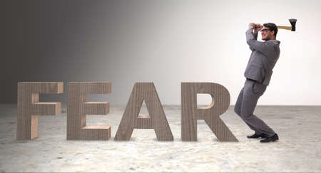 Angry man with axe axing the word fearの写真素材