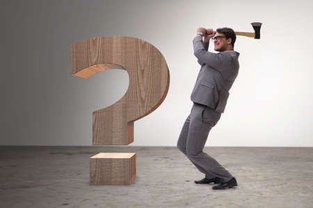 Angry man with axe axing the question markの写真素材