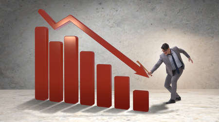 Angry man with baseball bat hitting downward chartの写真素材