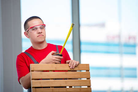 Young furniture carpenter in industrial concept
