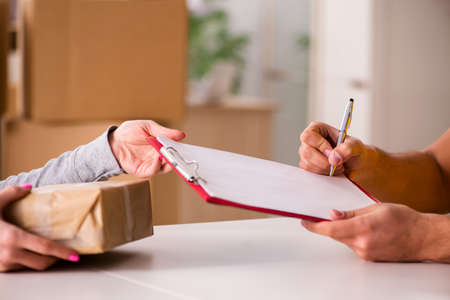 Delivery man delivering parcel boxの写真素材