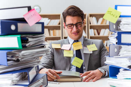 Businessman struggling with multiple prioritiesの写真素材