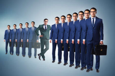 Standing out from the crown concept with businessmanの写真素材