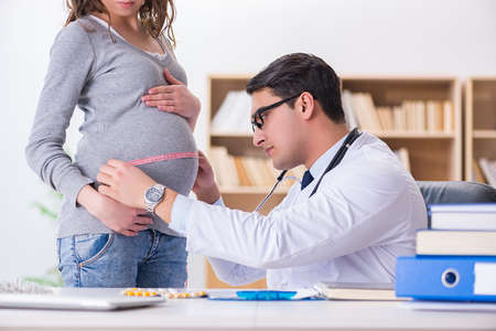 Pregnant woman visiting doctor for consultationの写真素材