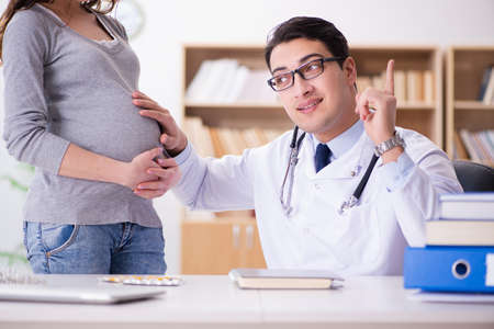 Pregnant woman visiting doctor for consultationの写真素材