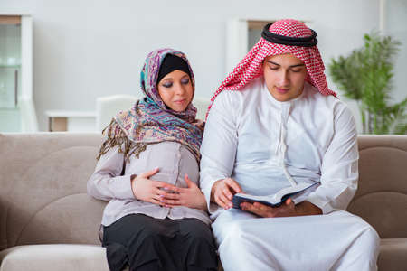 Young arab muslim family with pregnant wife expecting babyの写真素材