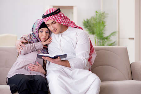 Young arab muslim family with pregnant wife expecting babyの写真素材