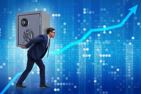 BUsinessman stealing metal safe from bankの写真素材