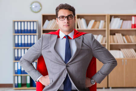 Superhero businessman working in the officeの写真素材