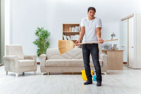 Man husband cleaning the house helping wifeの写真素材