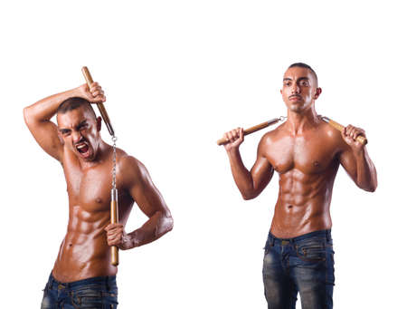 Martial arts warrior with nunchucks on whiteの写真素材