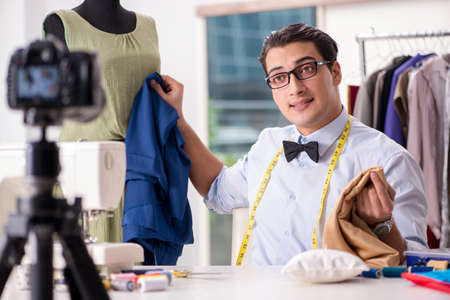 Young man working as fashion video bloggerの写真素材