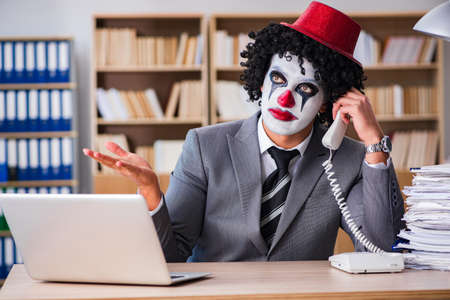 Clown businessman working in the officeの写真素材
