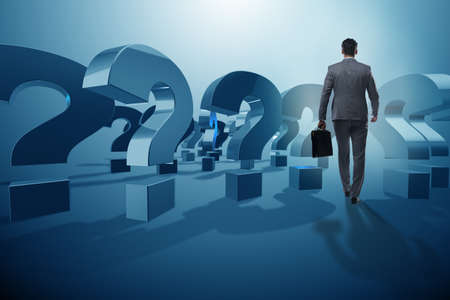 Businessman in uncertainty concept with question marksの写真素材