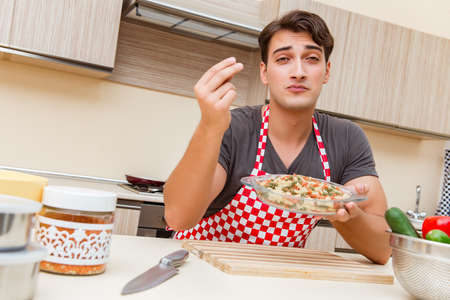 Man male cook preparing food in kitchen