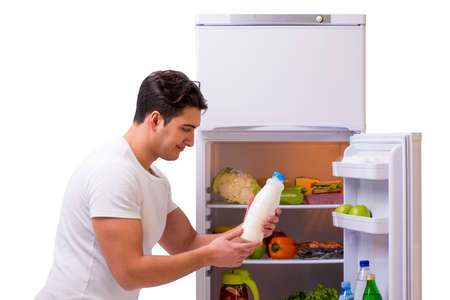 Man next to fridge full of foodの写真素材