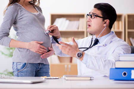 Pregnant woman visiting doctor for consultationの写真素材