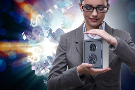 Businesswoman holding metal safe in security conceptの写真素材