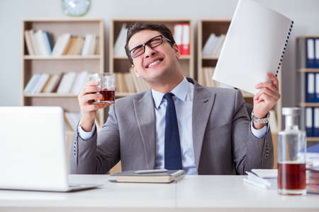 Businessman drinking in the officeの写真素材