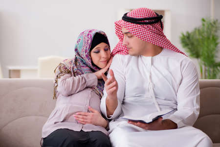 Young arab muslim family with pregnant wife expecting babyの写真素材