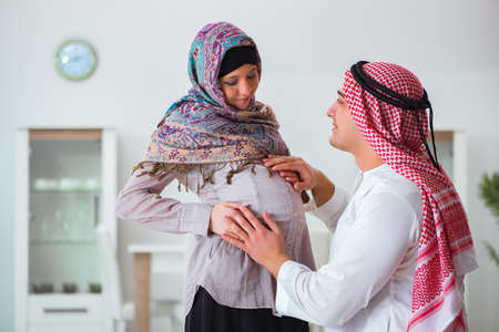 Young arab muslim family with pregnant wife expecting babyの写真素材