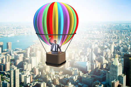 Businessman flying on balloon in challenge conceptの写真素材