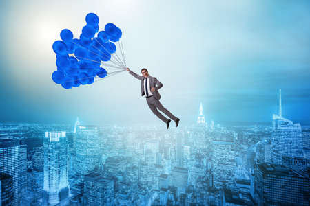 Businessman flying on balloon in challenge conceptの写真素材
