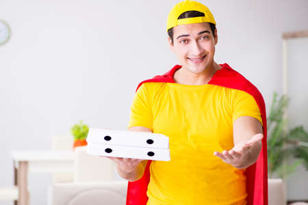 Superhero pizza delivery guy with red coverの写真素材