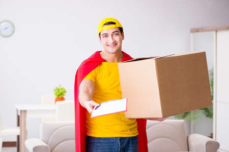 Superhero delivery guy with boxの写真素材
