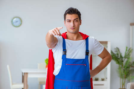 Super hero repairman working at homeの写真素材