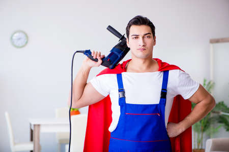 Superhero repairman with tools in repair conceptの写真素材