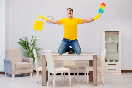 Man husband cleaning the house helping his wife