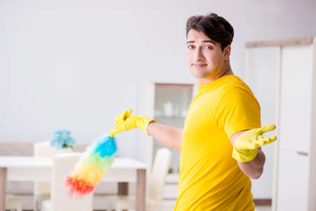 Man husband cleaning the house helping his wifeの写真素材