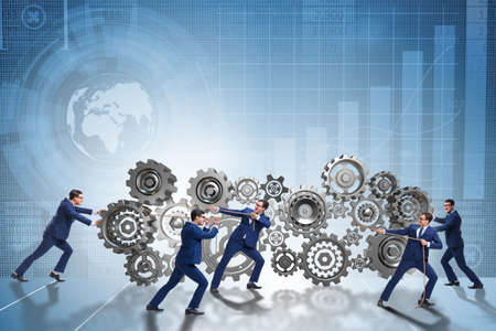 Businessman in teamwork concept with cogwheelsの写真素材