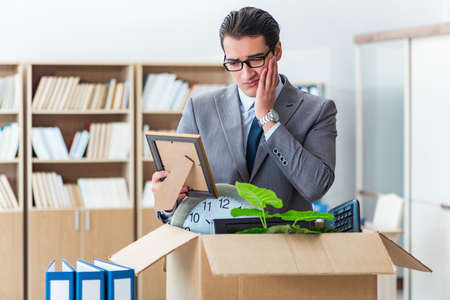 Man moving office with box and his belongingsの写真素材