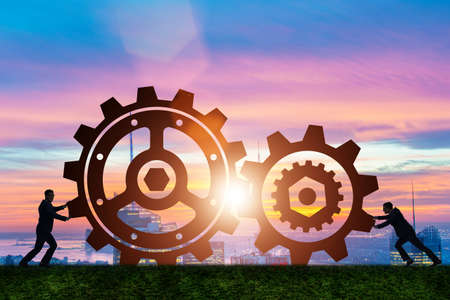 Businessman in teamwork concept with cogwheelsの写真素材