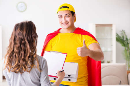 Superhero pizza delivery guy with red coverの写真素材