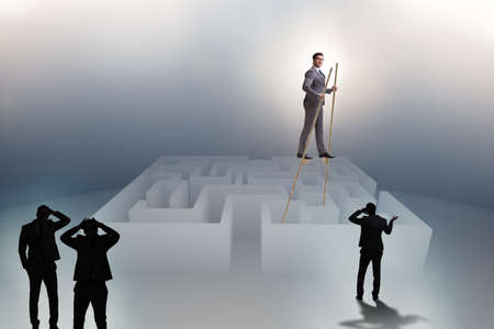 Businessman walking on stilts - standing out from the crowdの写真素材