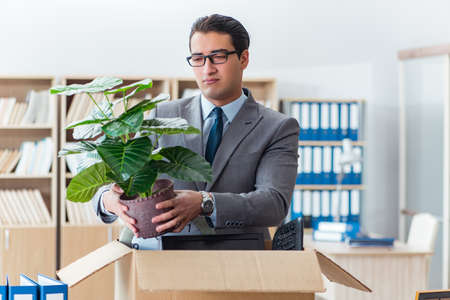 Man moving office with box and his belongingsの写真素材